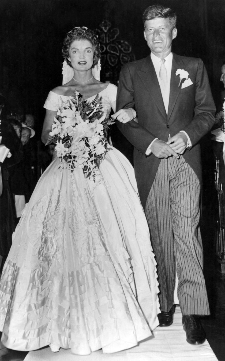 John Fitzgerald Kennedy walks his bride Jacqueline Lee Bouvier down the church aisle shortly after their wedding ceremony in Newport, Rhode Island