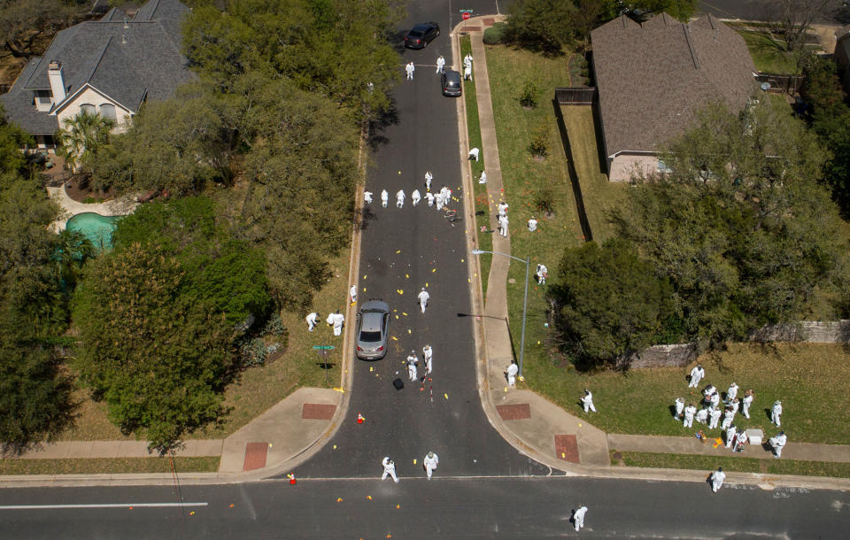 <p>Investigators on Monday March 19, 2018, work at the scene of a bomb explosion on Dawn Song Drive in Austin, Texas, that seriously injured two men Sunday. Two people have now been killed and four wounded in bombings over a span of less than three weeks. (Photo: Jay Janner/Austin American-Statesman via AP) </p>