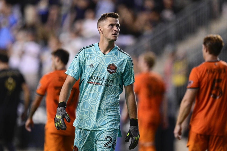 Houston Dynamo goalkeeper Michael Nelson watches a replay after giving up a goal during the first half of the team's MLS soccer match against the Philadelphia Union, Saturday, July 30, 2022, in Chester, Pa. (AP Photo/Derik Hamilton)