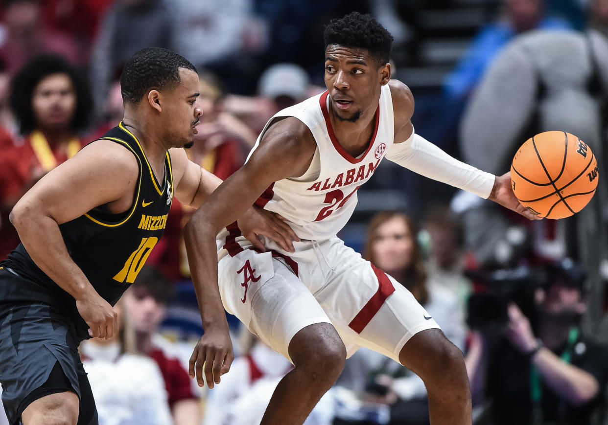 NASHVILLE, TN - MARCH 11: Alabama Crimson Tide forward Brandon Miller (24) controls the ball against Missouri Tigers guard Nick Honor (10) during an SEC Mens Basketball Tournament game between the Alabama Crimson Tide and the Missouri Tigers on March 11, 2023 at Bridgestone Arena in Nashville, TN. (Photo by Bryan Lynn/Icon Sportswire via Getty Images)