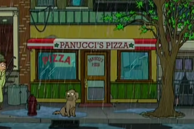 Seymour standing outside Panucci's Pizza in the rain