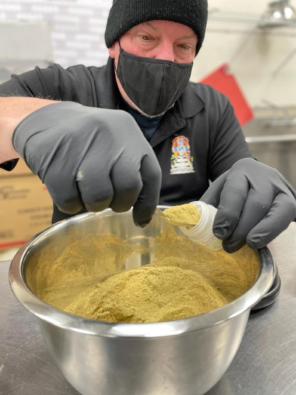 Dennis Pruszka fills each seasoning blend by hand in a commercial kitchen in Hales Corners.