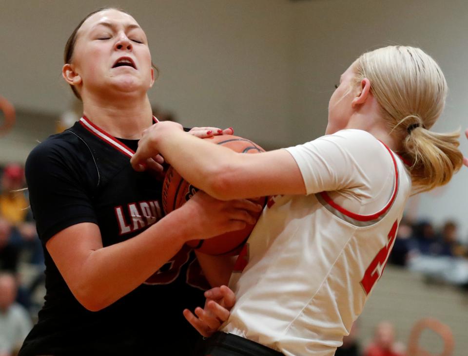 Rensselaer Central Bombers Kamri Rowland (30) and West Lafayette Red Devils Vivian Huston (24) fight for a loose ball during the IU Health Hoops Classic Girl’s Basketball Championship, Saturday, Nov. 18, 2023, at Harrison High School in West Lafayette, Ind. Rensselaer Central Bombers won 58-53.