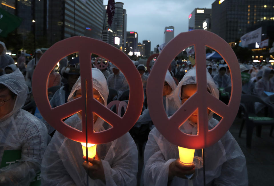 <p>People hold candles during a rally wishing for a successful summit between President Donald Trump and North Korea’s leader Kim Jong Un and peace on the Korea peninsular near the U.S. embassy in Seoul, South Korea, Saturday, June 9, 2018. (Photo: Lee Jin-man/AP) </p>