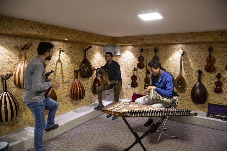 Young Palestinians play instruments in Gaza’s first music shop (Photo: Bel Trew)