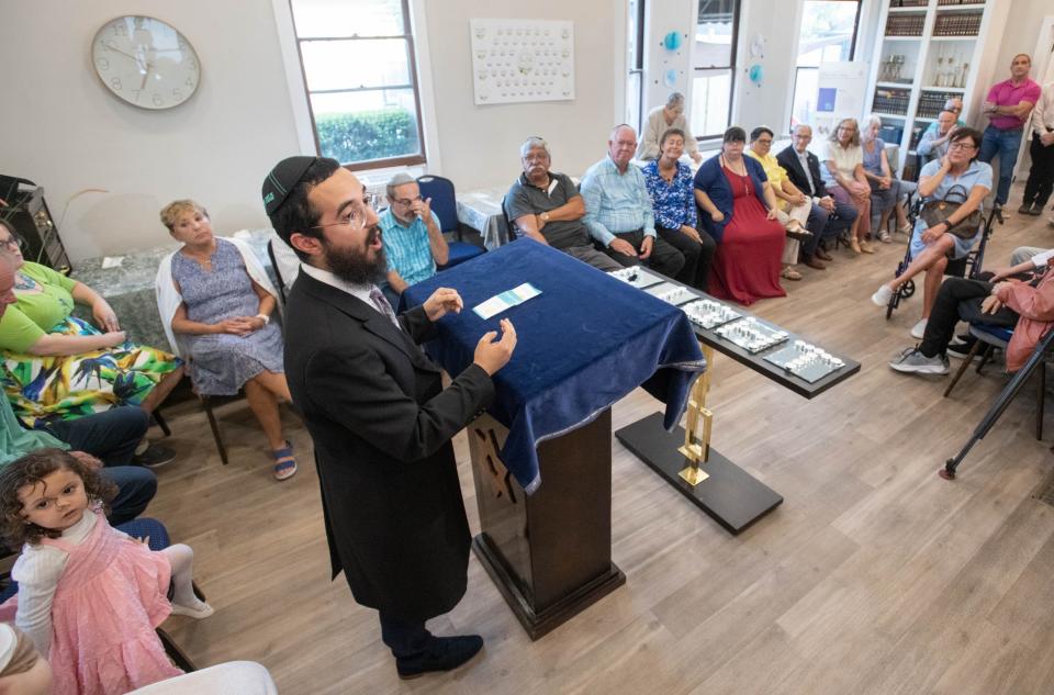 Rabbi Mendel Danow speaks during the Light Up Pensacola! - Combating Hate with Light and Kindness gathering at the Chabad Jewish Center in Pensacola on Friday, July 21, 2023. The event is in response to a brick covered in antisemitic and white supremacist language being throw through a window of the building earlier in the week.