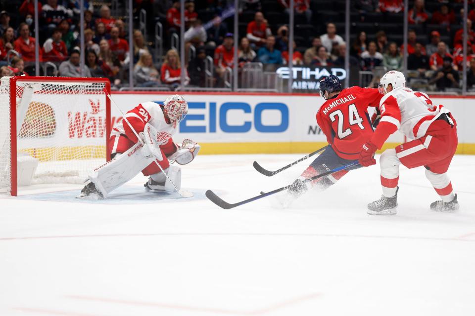 Capitals center Connor McMichael skates in on Red Wings goaltender Alex Lyon as defenseman Justin Holl defends in the first period of the exhibition on Thursday, Sept. 28, 2023, in Washington.