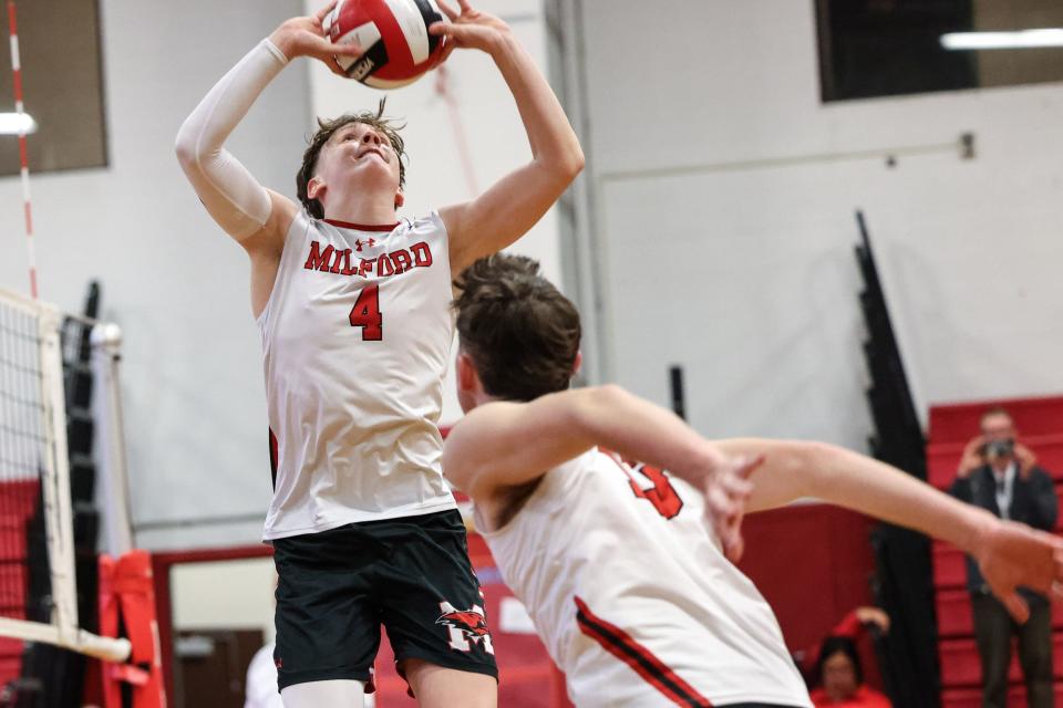 Milford’s Owen Callahan sets the ball during the Round of 16 playoff game against Wayland at Milford High School on Jun. 07, 2023.