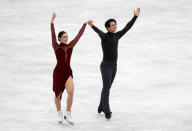 Figure Skating - ISU Grand Prix of Figure Skating NHK Trophy - Ice Dance Free Dance - Osaka, Japan - November 12, 2017 - Tessa Virtue and Scott Moir of Canada wave to fans after their performance. REUTERS/Kim Kyung-Hoon