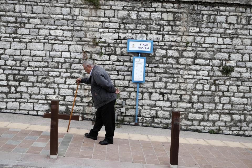 In this Tuesday, May 14, 2019, photo an elderly man walks uphill in Karpenisi town, at Evrytania region, in central Greece. The area, a winding, three-hour drive from Athens, has the oldest population in the whole European Union, 54.3 on average. (AP Photo/Thanassis Stavrakis)