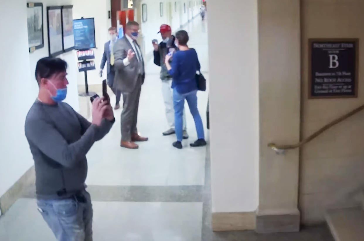Video showing the same man taking photos of hallways and staircases on the tour led by Loudermilk. (Capitol Police )