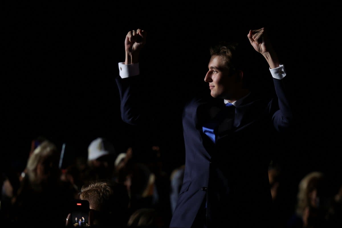 Barron waves and pumps his fist as Trump introduces youngest son to