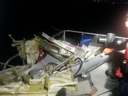 The wreckage of a plane that crashed into the Atlantic Ocean is brought aboard a U.S. Coast Guard boat off the coast of Fort Lauderdale, Florida November 19, 2013. REUTERS/U.S. Coast Guard/Handout