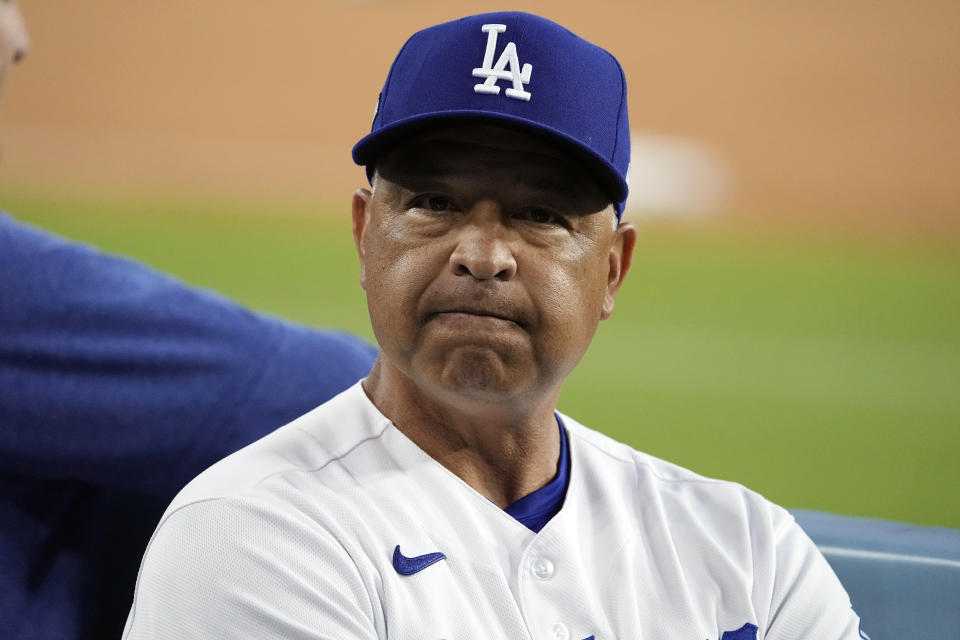 Los Angeles Dodgers manager Dave Roberts watches from the dugout before Game 2 of a baseball NL Division Series against the Arizona Diamondbacks, Monday, Oct. 9, 2023, in Los Angeles. (AP Photo/Mark J. Terrill)