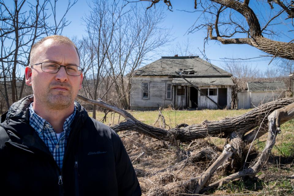 Osceola City Manager Ty Wheeler stands in front of an early 20th century farmstead that an official from Iowa's State Historic Preservation Office says  should be considered for placement on the National Register of Historic Places ― possibly endangering plans for a much-needed reservoir there. Local officials disagree.