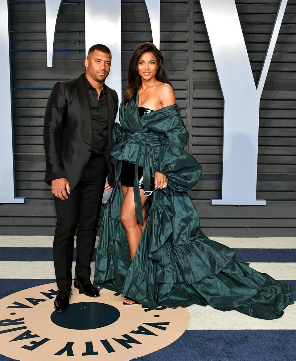 <p>The singer opted for high volume in her green Alexandre Vauthier gown, while her NFL star husband kept it simple in a black-on-black suit. (Photo: Dia Dipasupil/Getty Images) </p>