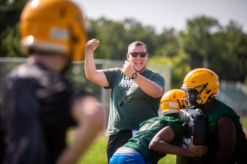 Coach Theo Evans leads a Des Moines Hoover football practice this month at the high school.