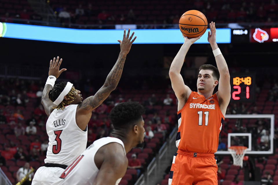 Syracuse guard Joseph Girard III (11) shoots over Louisville guard El Ellis (3) during the first half of an NCAA college basketball game in Louisville, Ky., Tuesday, Jan. 3, 2023. (AP Photo/Timothy D. Easley)