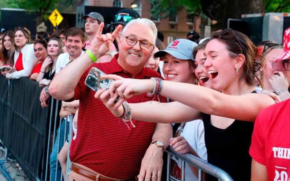 N.C. State Chancellor Randy Woodson poses with students during a celebration for the N.C. State men’s and women’s basketball team at the Memorial Belltower in Raleigh, N.C., Monday, April 15, 2024. Both teams made it to the NCAA Tournament Final Four and the men’s team won the ACC Championship by winning five games in five days.