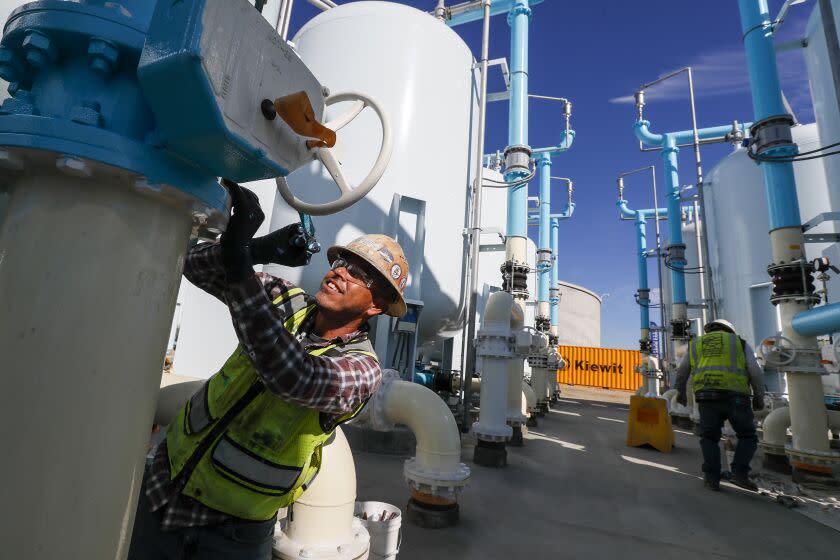 Sun Valley, CA, Tuesday, November 22, 2022 -Sergio Lopez paints a filtration tank as construction continues at LADWP's Tujunga Spreading Grounds facility where groundwater from the San Fernando basin is treated. The groundwater became contaminated years ago after toxic chemicals seeped into the basin. (Robert Gauthier/Los Angeles Times)