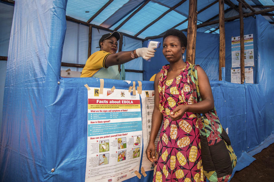 In this photo provided by the International Rescue Committee, a Congolese refugee is screened for Ebola symptoms at the IRC triage facility in the Kyaka II refugee settlement in Kyegegwa District in western Uganda, Thursday, June 13, 2019. The Congolese pastor who is thought to have caused the Ebola outbreak's spread into Uganda was unknown to health officials before he died of the disease, the World Health Organization's emergencies chief said Thursday, underlining the problems in tracking the virus. (Kellie Ryan/International Rescue Committee via AP)