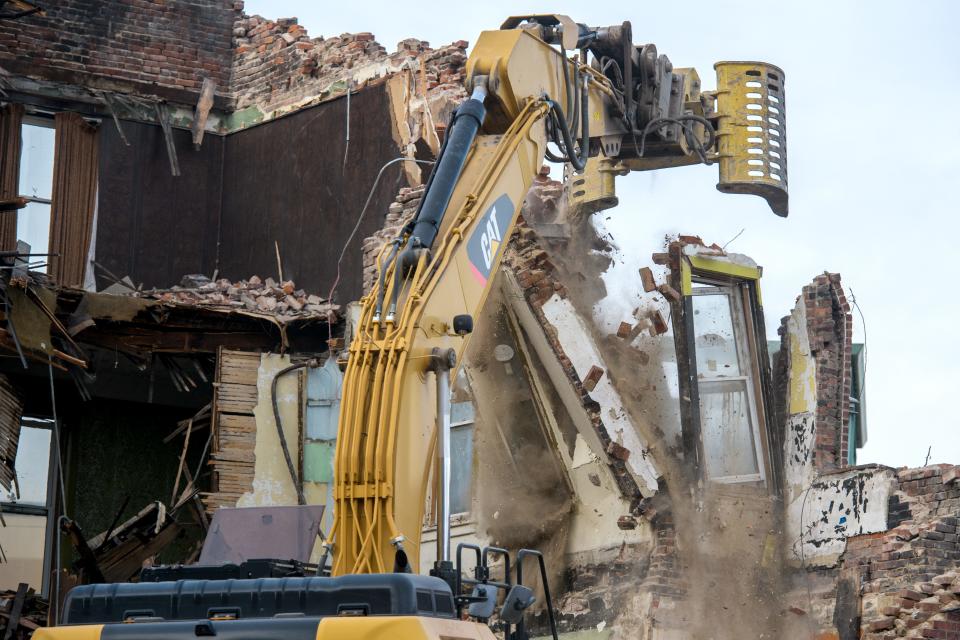 A corner section of the former Julian Hotel comes tumbling down during demolition Tuesday, Dec. 19, 2023 in Peoria.