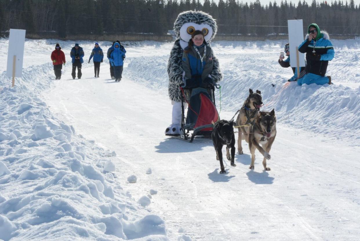 The 2018 Arctic Winter Games (AWG) mascot rides with an Alaska athlete. The 2018 games was the last time dog mushing was an AWG event, and only teams from the N.W.T. and Alaska participated that year. The sport won't be part of this year's games in Alaska. (Philippe Morin/CBC - image credit)