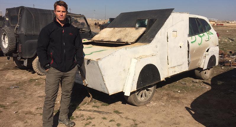 Reporter Denham Hitchcock with a captured vehicle car bomb in eastern Mosul