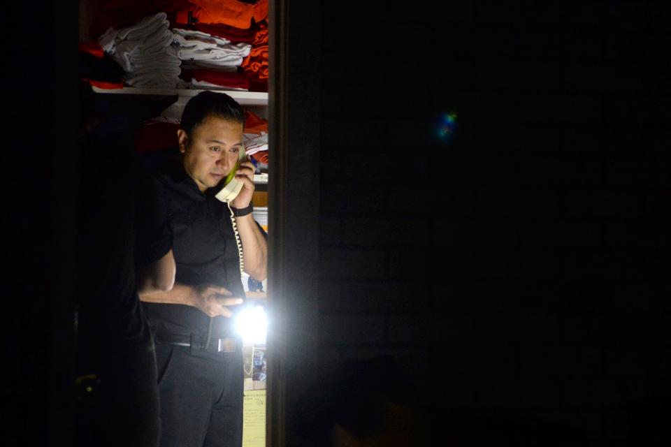 Daniel Almanza of Bayside Cafe, which was among businesses to lose power because of PG&E's public safety power shutoff, calls a supplier from the office of the restaurant in Sausalito, Calif., on Oct. 9, 2019.