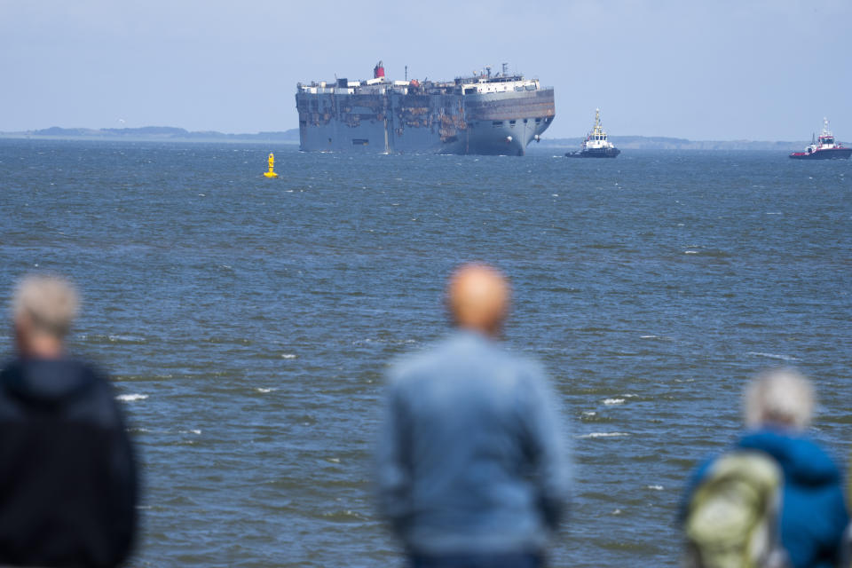 Stricken cargo ship Fremantle Highway, that caught fire while transporting thousands of cars, including nearly 500 electric vehicles, from Germany to Singapore, is towed into the port of Eemshaven, the Netherlands, on Thursday, Aug. 3, 2023. The ship that burned for almost a week close to busy North Sea shipping lanes and a world renowned migratory bird habitat will be salvaged at the northern Dutch port. (AP Photo/Peter Dejong)