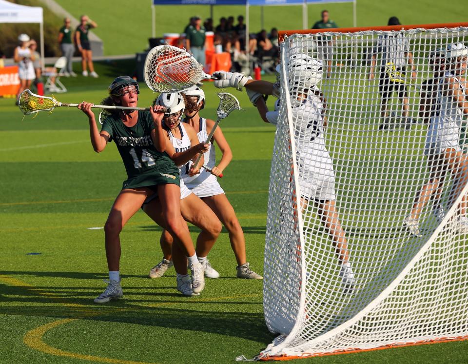Ashling Marshall of Saint Stephen's Episcopal looks for room to shoot against American Heritage in the Class 1A state girls lacrosse semifinal at Paradise Coast Sports Complex in Naples in 2023. American Heritage defeated the Falcons 22-5.