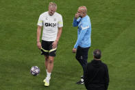 Manchester City's head coach Pep Guardiola shares a laugh with Manchester City's Erling Haaland during a training session at the Ataturk Olympic Stadium in Istanbul, Turkey, Friday, June 9, 2023. Manchester City and Inter Milan are making their final preparations ahead of their clash in the Champions League final on Saturday night. (AP Photo/Thanassis Stavrakis)