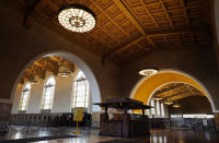 The interior of Union Station in Los Angeles appears on March 23, 2021. The Oscars are headed to the historic site for the first time this year. With wide open spaces and 65-foot high ceilings, it’s ideal for a big crew and cameras. It’s been used in car commercials, reality shows and procedurals. But its beamed ceilings, Spanish tile floors and regal bronze chandeliers really shine in cinema where it’s played train stations, banks, police stations, clubs and airports. (AP Photo/Chris Pizzello)