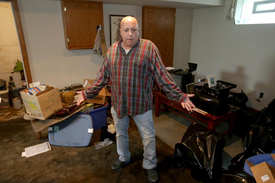 North Canton resident Dan Schoenberg stands in his basement that was flooded with raw sewage. The city estimated hundreds of homes were impacted by a flash flood in the community on Saturday.