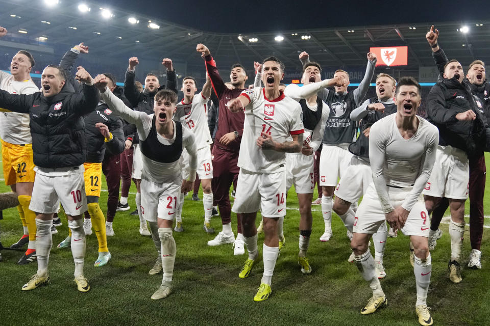 Poland players celebrate after defeating Wales in a penalty shoot out during their Euro 2024 soccer play-off match at Cardiff City Stadium, Wales, Tuesday, March 26, 2024. (AP Photo/Alastair Grant)