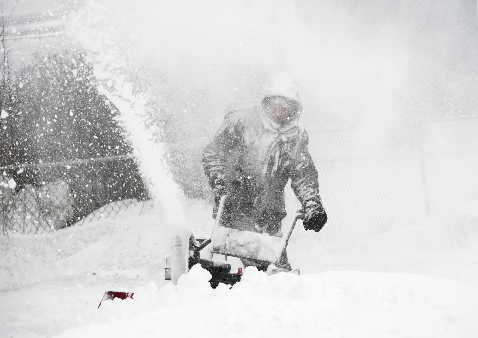 Kyle Binette is surrounded by wind-driven snow while snow blowing his driveway during a nor’easter in Biddeford, ME. Gregory Rec/Getty Images.