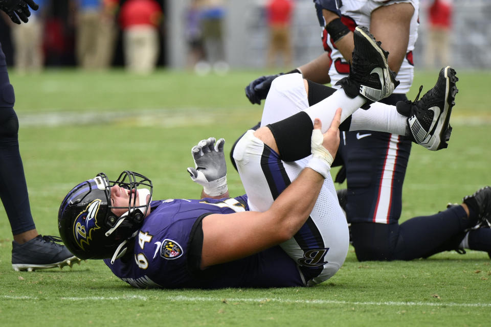 FILE - Baltimore Ravens center Tyler Linderbaum (64) lies on the field injured during the second half of an NFL football game against the Houston Texans, Sunday, Sept. 10, 2023, in Baltimore. No injuries cause more lost time in the NFL than those painful pulls and pesky strains of the leg muscles that give players the burst they need to keep up in this speed-based game. The league has committed millions of dollars to studying, treating and preventing these lower extremity injuries, seeing progress in minimizing the problems with the hamstring, quad, calf and the like. (AP Photo/Nick Wass, File)