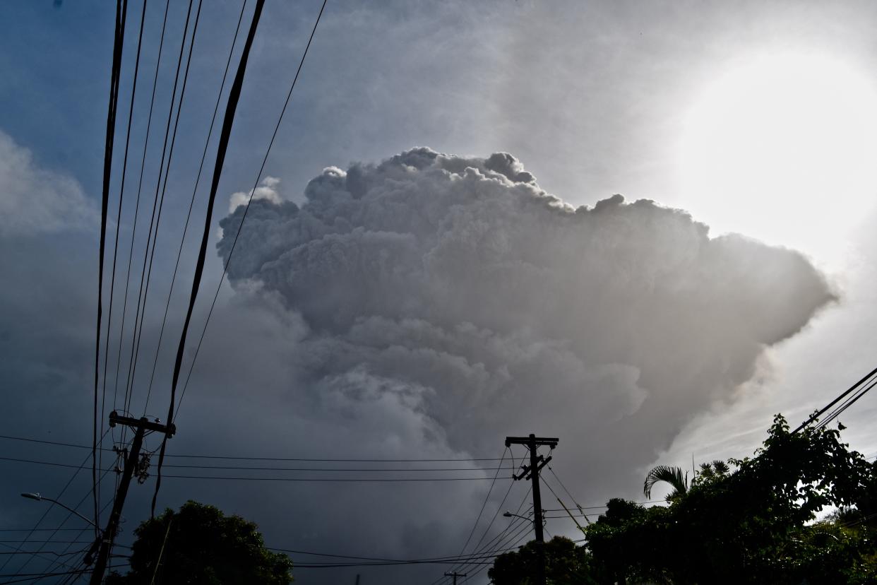 Ash rises into the air as La Soufriere volcano erupts on the eastern Caribbean island of St. Vincent, seen from Chateaubelair, Friday, April 9. 