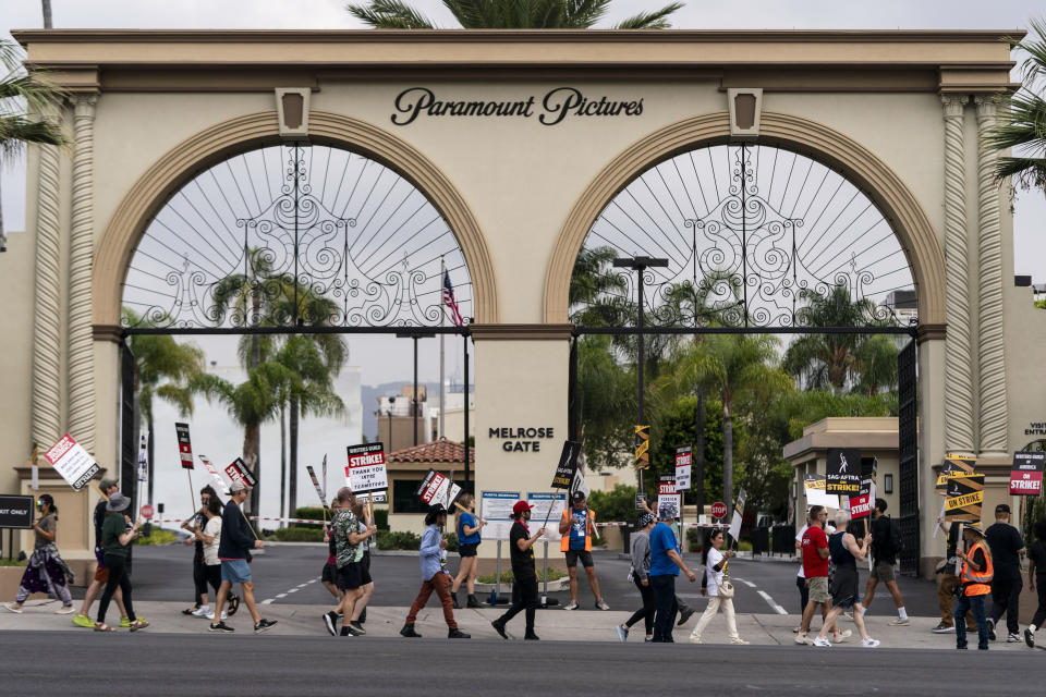 Demonstrators picket outside the Paramount Pictures Studio in Los Angeles, Thursday, Sept. 21, 2023. Negotiations between striking screenwriters and Hollywood studios have resumed and will continue Thursday, the latest attempt to bring an end to pickets that have brought film and television productions to a halt. (AP Photo/Jae C. Hong)