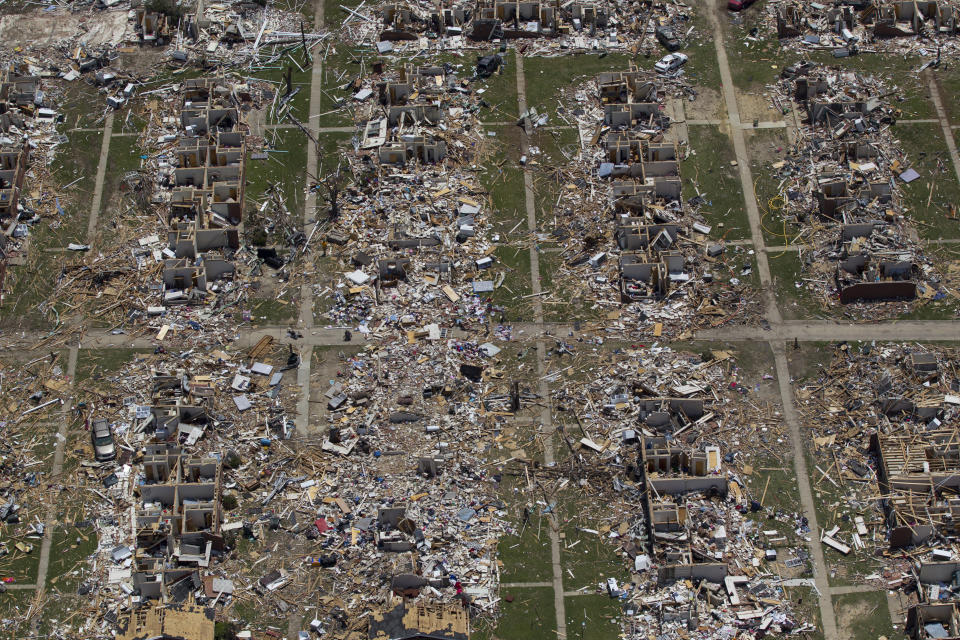 FILE - Debris covers the ground in the aftermath of a tornado in Tuscaloosa, Ala., May 7, 2011. Meteorologists are warning of a series of severe storms that could rip across America’s Midwest and South over the next couple of weeks. One weather expert said the current persistent pattern of storm ingredients is consistent with the April 2011 tornado onslaught, one of the largest, deadliest and most destructive tornado outbreaks in American history. (AP Photo/Dave Martin, File)