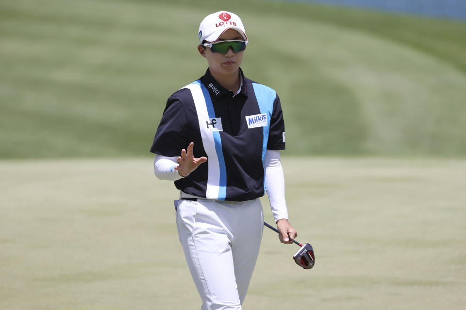 Hyo Joo Kim, of South Korea, waves to the gallery on the ninth green during the first round of the LPGA golf tournament, Wednesday, April 12, 2023, near Honolulu. (AP Photo/Marco Garcia)