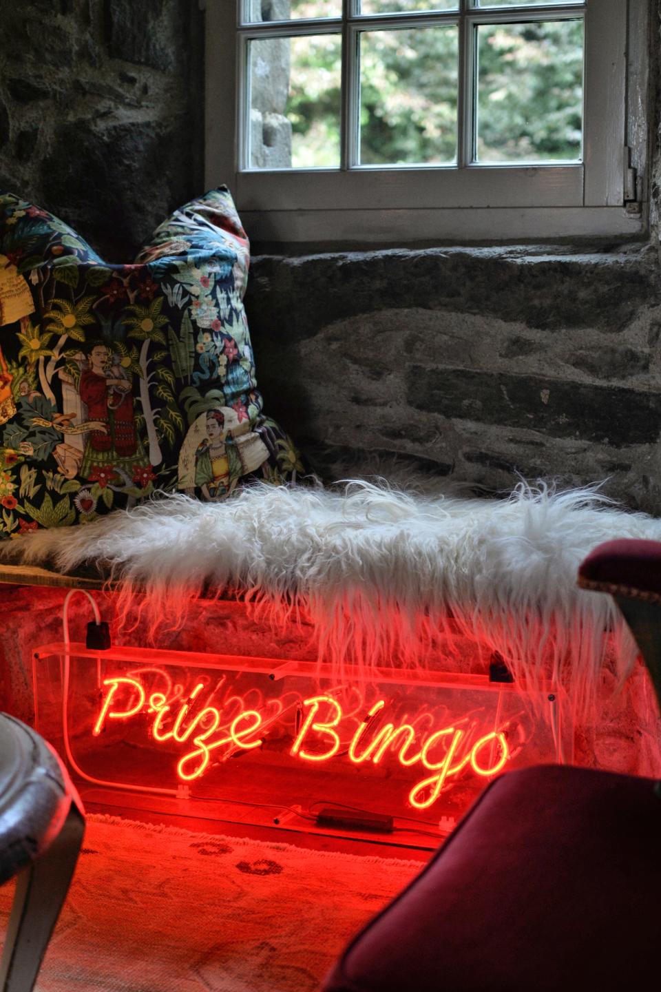 A window seat nook in Kilberry Castle, which features a neon bingo hall sign.