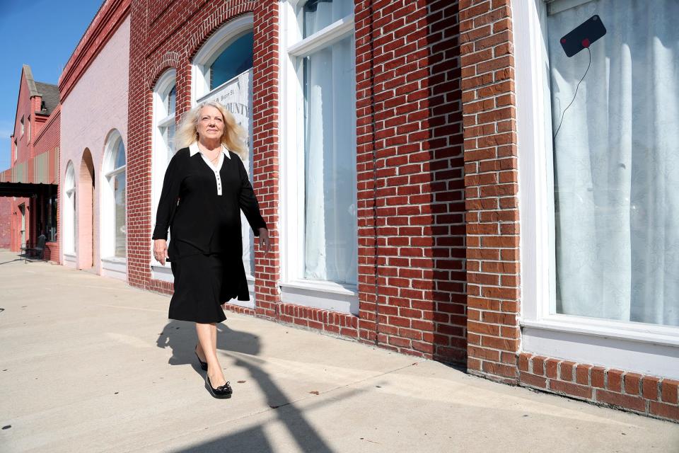 Mayoral candidate Sharroll Fanslau walks along the sidewalk in Historic Pembroke, Georgia.