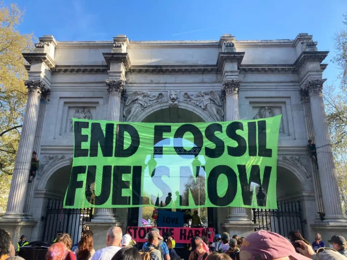 Activists hang a banner from Marble Arch in London on Saturday (Gareth Morris/Extinction Rebellion)