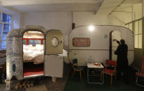 A caravan turned into sleeping accommodations is pictured in the indoor camping hotel Huettenpalast in Berlin, May 5, 2011. A 200 square metre production hall of a small vacuum-cleaner factory was used to create an indoor garden where guests can sleep in old caravans and wooden huts. REUTERS/Tobias Schwarz