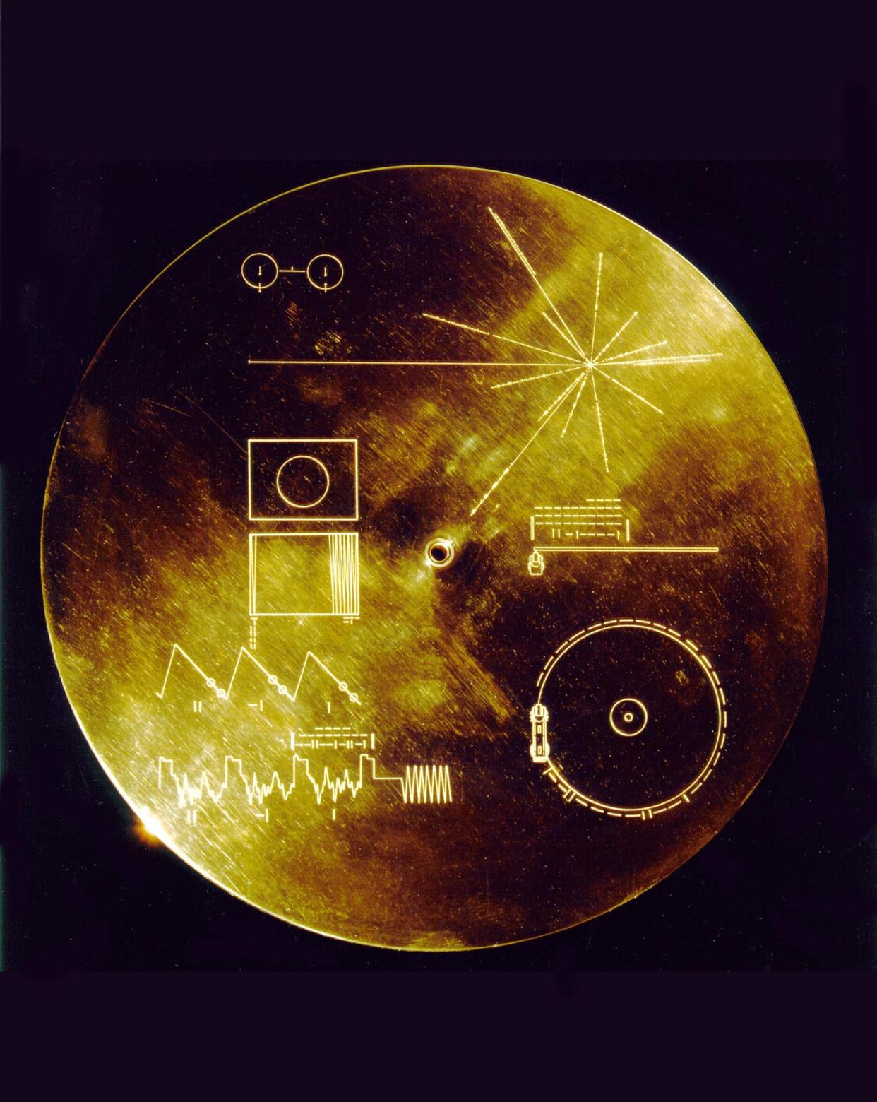 This 1977 NASA file image shows a gold aluminum cover that was designed to protect the Voyager 1 and 2 "Sounds of Earth" gold-plated records, which also provides the finder a key to playing the record. The identical "golden" records are carrying the story of Earth far into deep space.