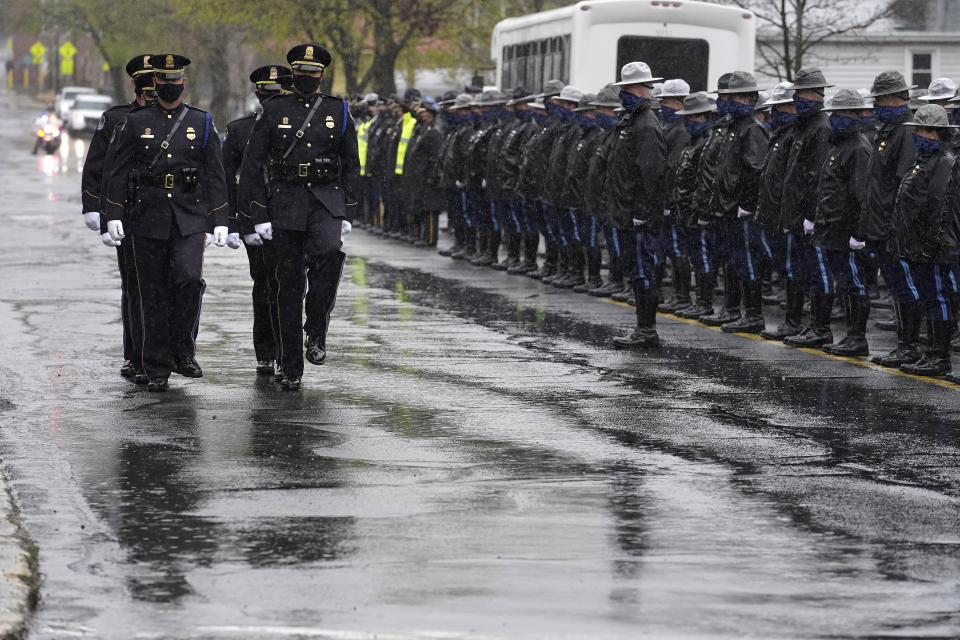 Pallbearers from the U.S. Capitol Police, left, process past Massachusetts state police, right, as they approach St. Stanislaus Kostka Church before a funeral Mass for William "Billy" Evans, Thursday, April 15, 2021, in Adams, Mass. Evans, a member of the U.S. Capitol Police, was killed on Friday, April 2, when a driver slammed his car into a checkpoint he was guarding at the Capitol. (AP Photo/Steven Senne)