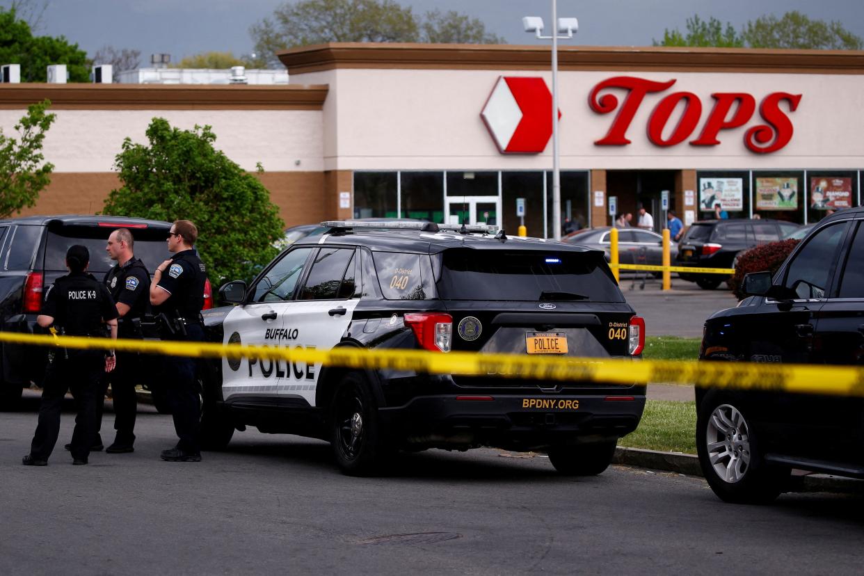 Police officers secure the scene after a shooting at TOPS supermarket in Buffalo, New York, U.S. May 14, 2022.