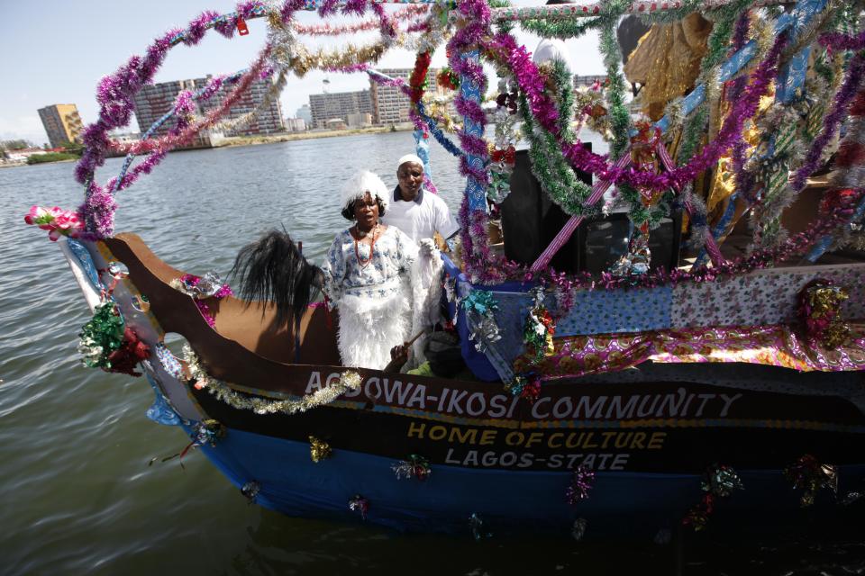 A woman dressed in costume takes part in a parade during a regatta in Lagos, Nigeria on Sunday, March. 31, 2013. Organizers held a boat regatta Sunday as part of the ongoing Lagos Carnival. The carnival will come to its height Monday as dancers and masqueraders walk through the streets of Lagos' two main islands.( AP Photos/Sunday Alamba)