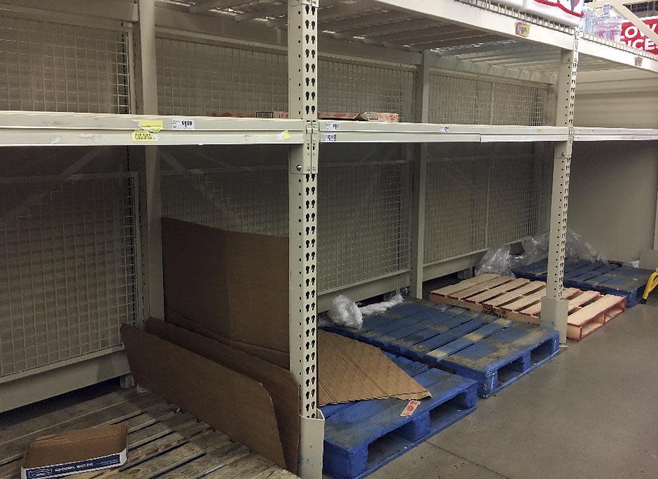 In this Thursday, Dec. 15, 2016 photo, empty shelves are left after residents rushed to H-E-B to buy water after a recent back-flow incident in the industrial district according to a city news release, in Corpus Christi, Texas. (Gabe Hernandez/Corpus Christi Caller-Times via AP)